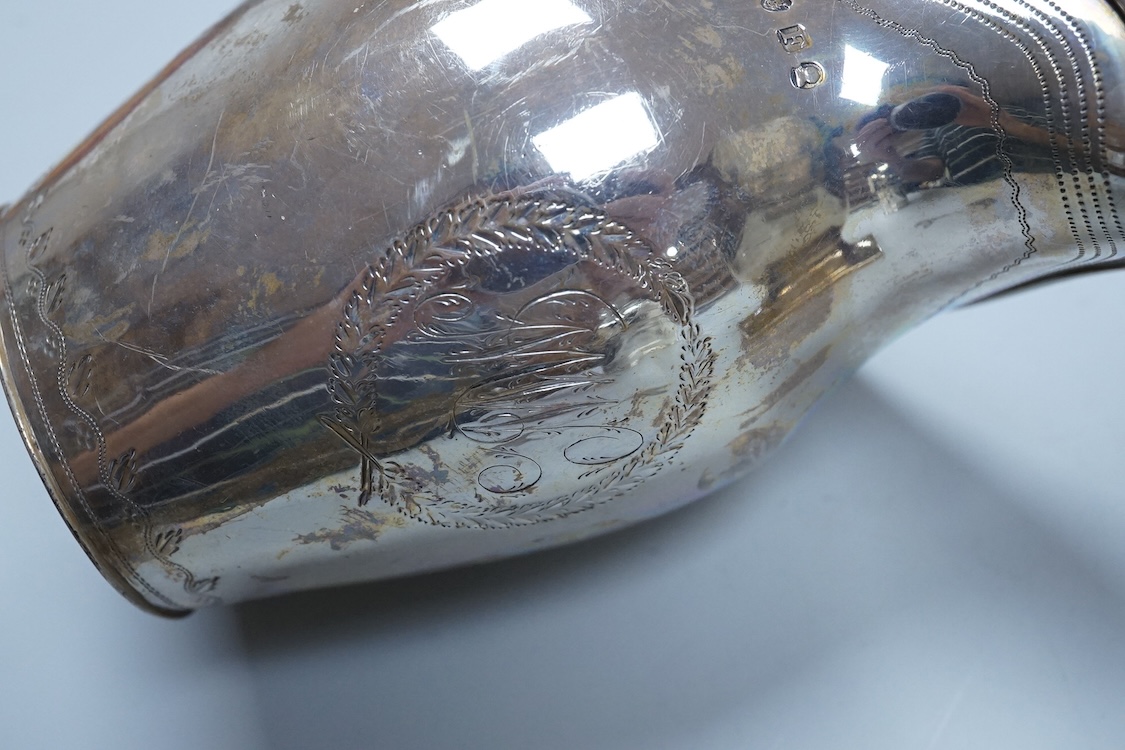 A George III silver cream jug, of oval form, London, 1801, 11cm, a George III silver helmet shaped cream jug, London, 1793, a George III small silver sugar pail, London, 1799 and a George V silver 'whisky' label, 8.4oz.